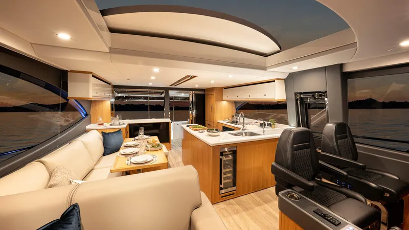 Slide: The Image of Luxurious interior of the 2024 Riviera 585 SUV yacht with modern kitchen and seating area. - 12