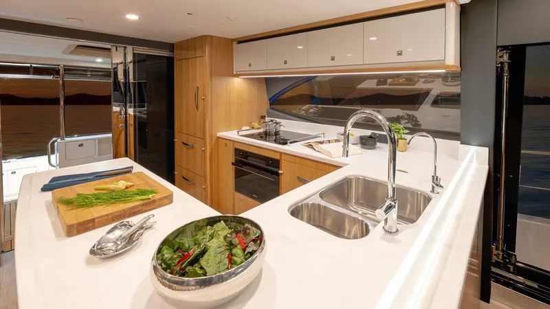 Slide: The Image of Modern kitchen interior of 2024 Riviera 585 SUV yacht with sleek design. - 15