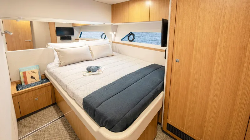 Slide: The Image of Luxurious bedroom interior of 2024 Riviera 585 SUV yacht with ocean view. - 25