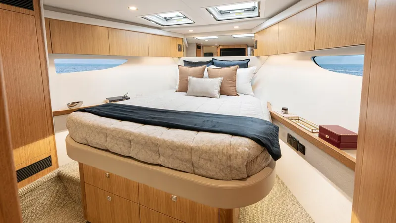 Slide: The Image of Luxurious bedroom interior of 2024 Riviera 585 SUV yacht with modern design and ocean view. - 27