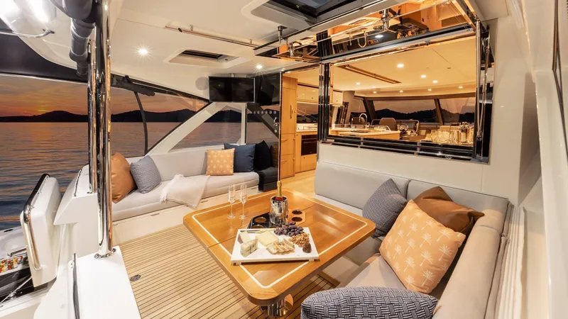 Slide: The Image of Luxurious interior of 2024 Riviera 585 SUV yacht with elegant seating and dining area. - 9