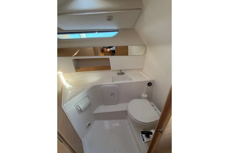 Slide: The Image of 2023 Nimbus Weekender 9 boat bathroom with modern fixtures and compact design. - 11