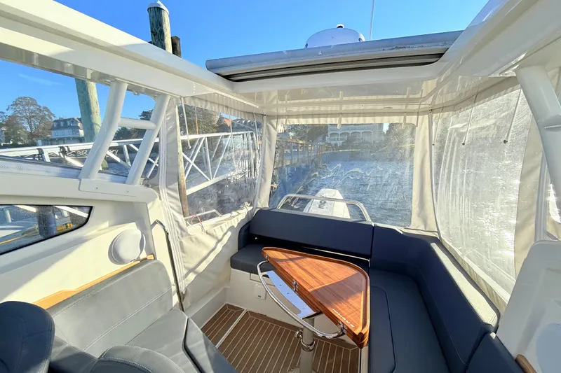 Slide: The Image of Interior of 2023 Nimbus Weekender 9 boat with seating and wooden table. - 5