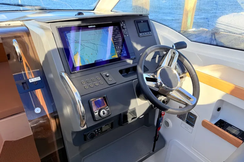 Slide: The Image of 2023 Nimbus Weekender 9 dashboard with steering wheel and navigation display. - 7