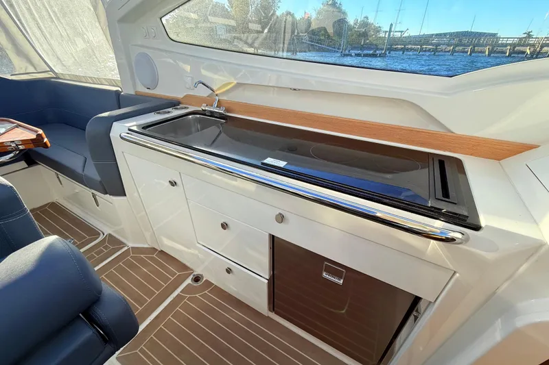 Slide: The Image of 2023 Nimbus Weekender 9 interior with sleek kitchenette and modern seating. - 8