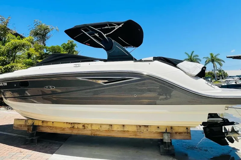 The Image of 2018 Sea Ray SLX 250 boat on display, featuring sleek design and black canopy. - 0