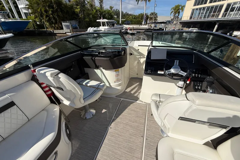 Slide: The Image of 2018 Sea Ray SLX 250 boat interior with luxurious seating and modern dashboard. - 18