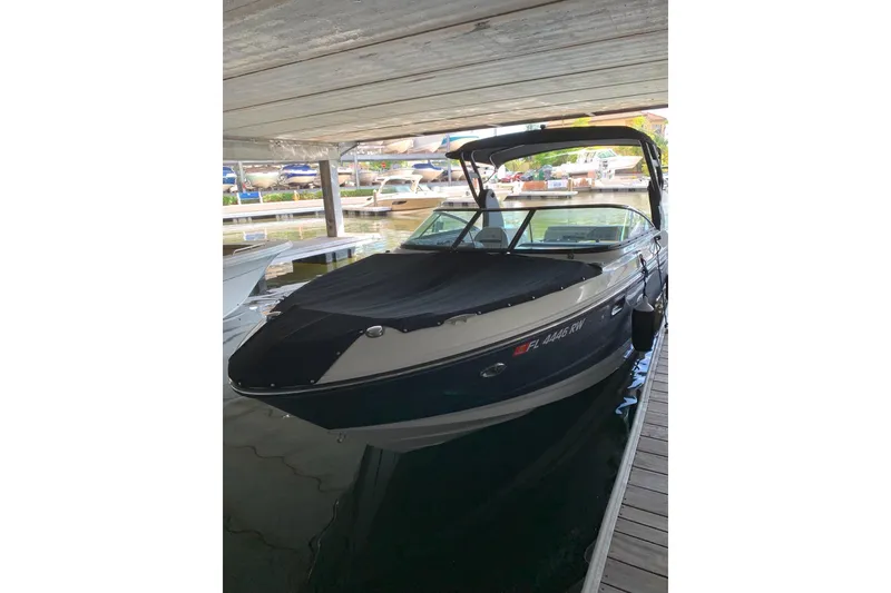 Slide: The Image of 2018 Sea Ray SLX 250 boat interior at Hidden Harbor Marina, showcasing seating and helm. - 2