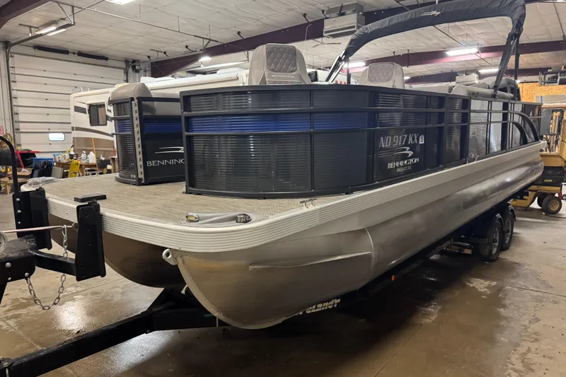 Slide: The Image of 2020 Bennington SXP 25 SSBXP pontoon boat in indoor storage facility. - 1