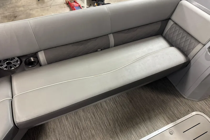 Slide: The Image of 2020 Bennington SXP 25 SSBXP boat interior with gray cushioned seating and cup holder. - 12