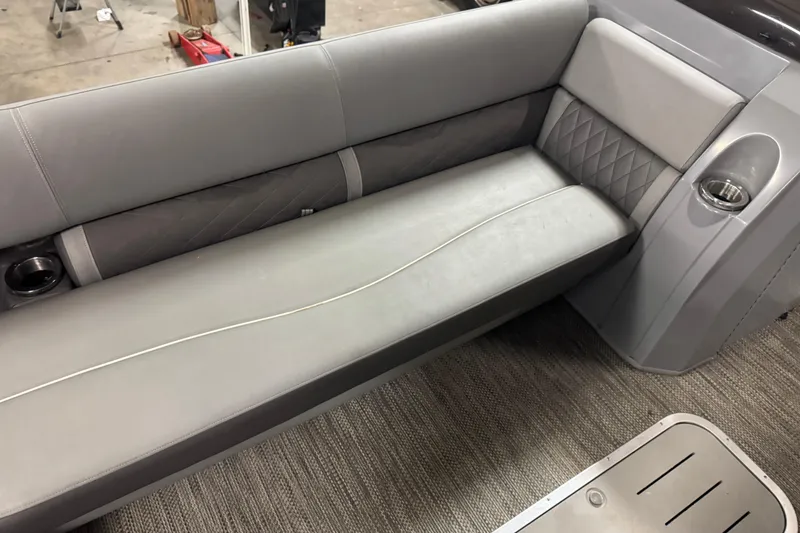 Slide: The Image of 2020 Bennington SXP 25 SSBXP boat interior with gray seating and cup holder. - 13