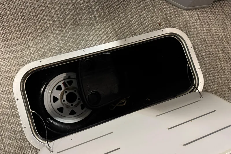 Slide: The Image of Storage compartment with spare tire in 2020 Bennington SXP 25 SSBXP boat. - 14