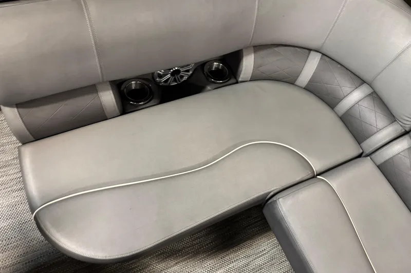 Slide: The Image of 2020 Bennington SXP 25 SSBXP boat interior with gray cushioned seating and cup holders. - 16