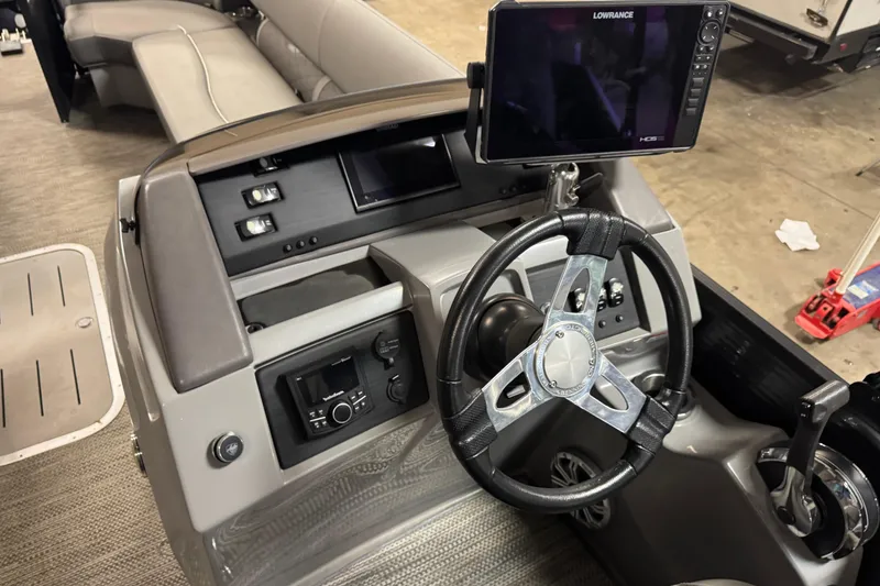 Slide: The Image of 2020 Bennington SXP 25 SSBXP boat dashboard with steering wheel and navigation system. - 23
