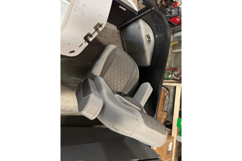 Slide: The Image of 2020 Bennington SXP 25 SSBXP boat seat with diamond-pattern upholstery in a workshop. - 26