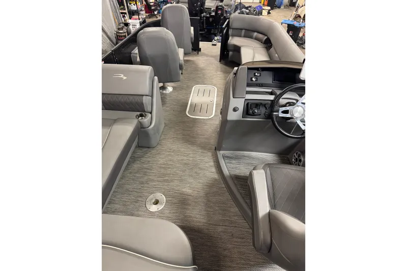 Slide: The Image of 2020 Bennington SXP 25 SSBXP pontoon boat interior with gray seating and steering console. - 28