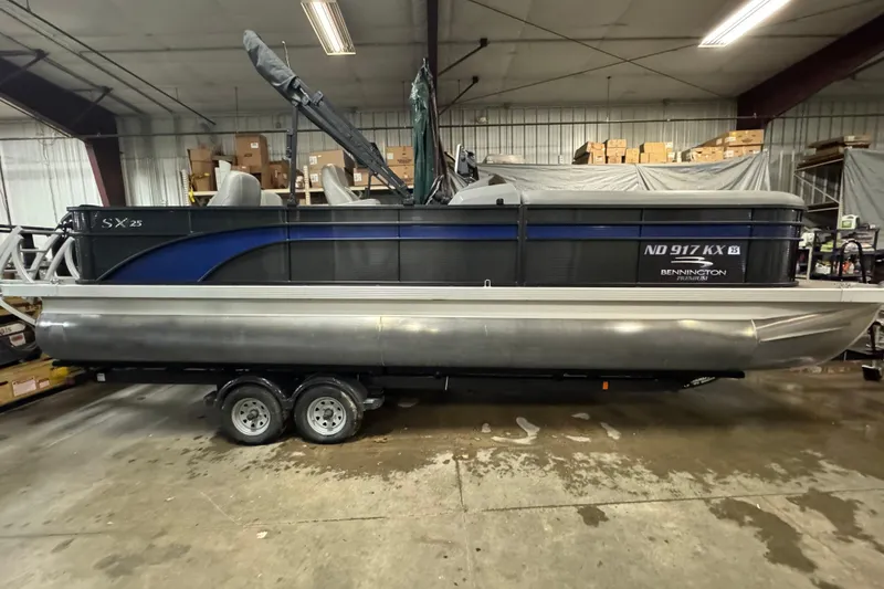 Slide: The Image of 2020 Bennington SXP 25 SSBXP pontoon boat in indoor storage on trailer. - 4