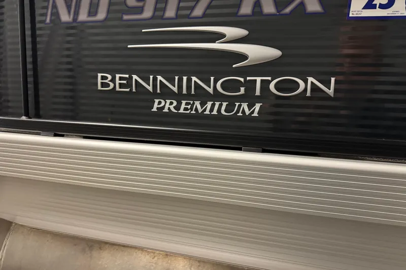 Slide: The Image of 2020 Bennington SXP 25 SSBXP pontoon boat with premium branding. - 7