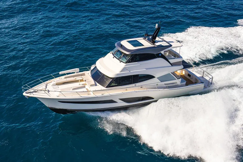 The Image of 2026 Riviera 64 Sports Motor Yacht Series II cruising on open water. - 0
