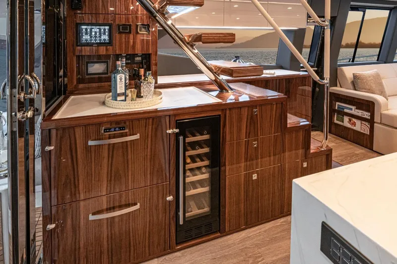 Slide: The Image of Luxurious interior of 2026 Riviera 64 Sports Motor Yacht Series II with elegant wood finishes. - 10