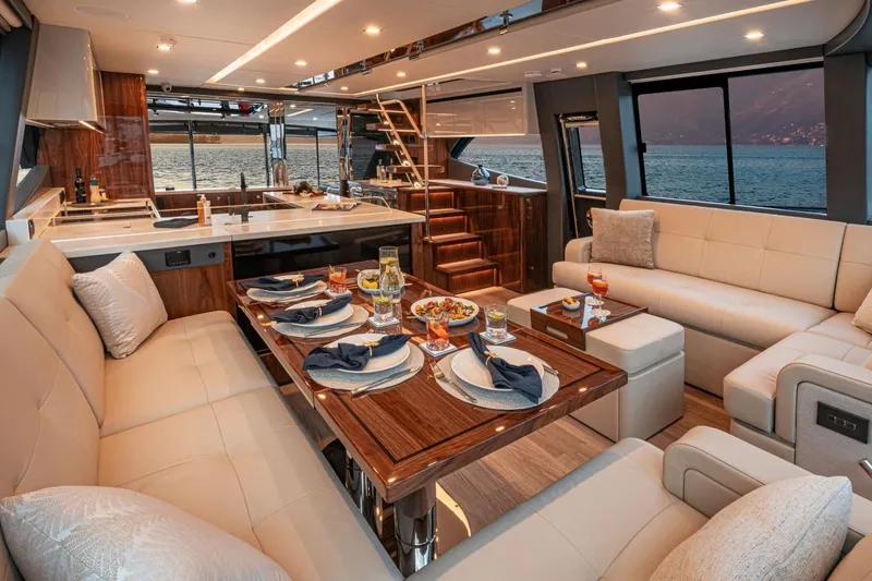 Slide: The Image of Luxurious interior of 2026 Riviera 64 Sports Motor Yacht, featuring elegant dining and seating areas. - 11