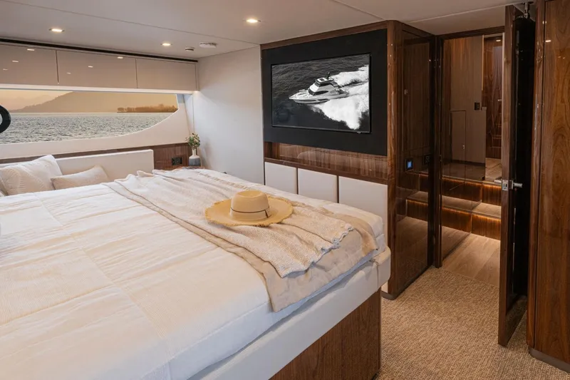 Slide: The Image of Luxurious bedroom in 2026 Riviera 64 Sports Motor Yacht Series II with scenic window view. - 14