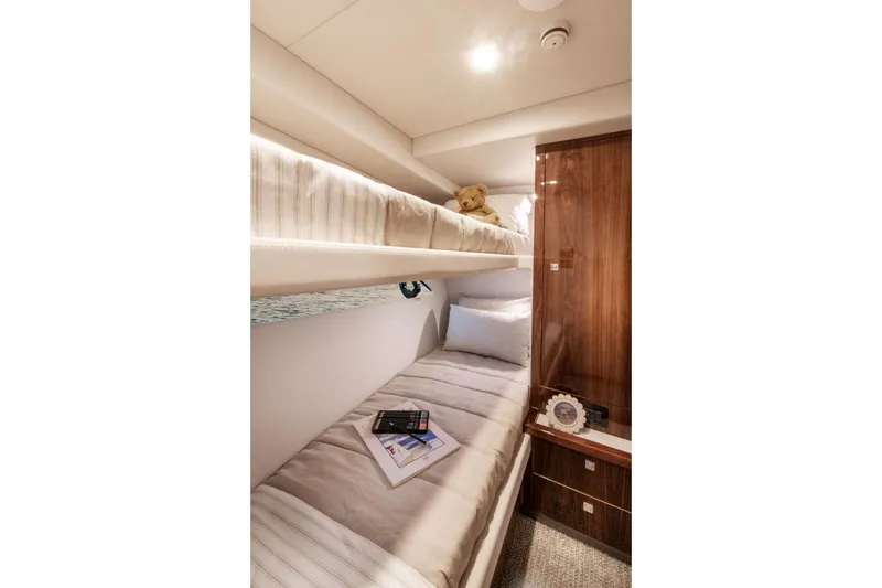 Slide: The Image of Luxurious cabin interior of 2026 Riviera 64 Sports Motor Yacht Series II with cozy bunk beds. - 20