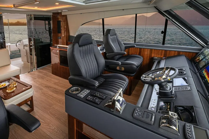 Slide: The Image of Luxurious interior of 2026 Riviera 64 Sports Motor Yacht Series II with modern helm and seating. - 21