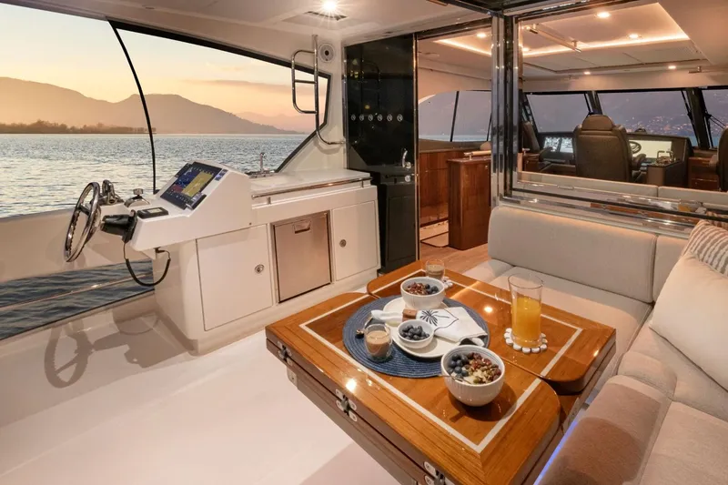Slide: The Image of Luxurious interior of 2026 Riviera 64 Sports Motor Yacht with scenic sunset view. - 22