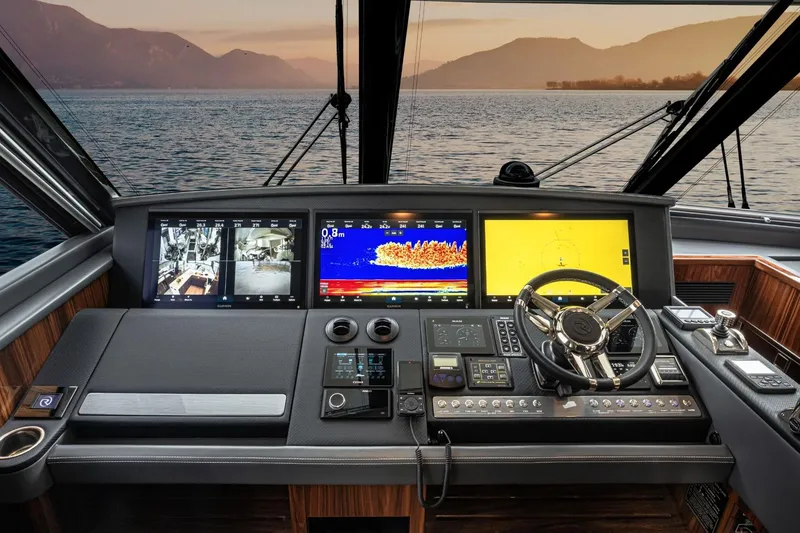 Slide: The Image of Helm of 2026 Riviera 64 Sports Motor Yacht Series II with advanced navigation displays. - 23