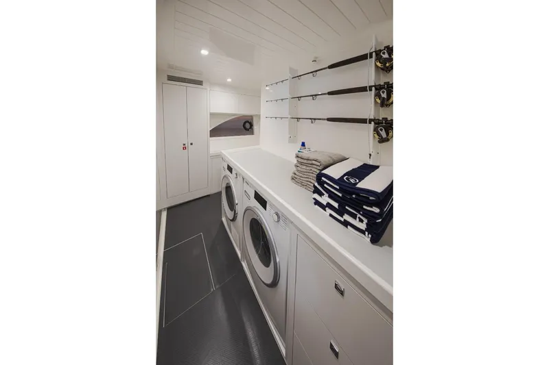 Slide: The Image of Laundry room in 2026 Riviera 64 Sports Motor Yacht Series II, featuring modern appliances and storage. - 25