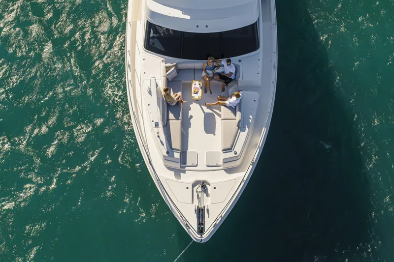 Slide: The Image of Aerial view of 2026 Riviera 64 Sports Motor Yacht with people relaxing on deck. - 5