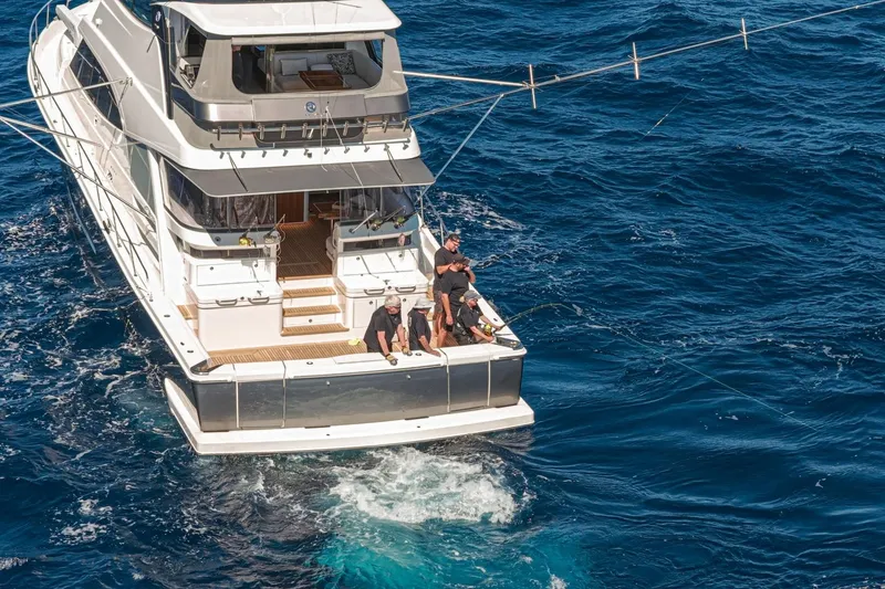 Slide: The Image of Riviera 68 Sports Motor Yacht Series II, 2026, cruising on open ocean with people fishing. - 3