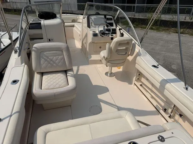 Slide: The Image of 2017 Grady-White Freedom 235 boat interior with seating and steering console. - 4