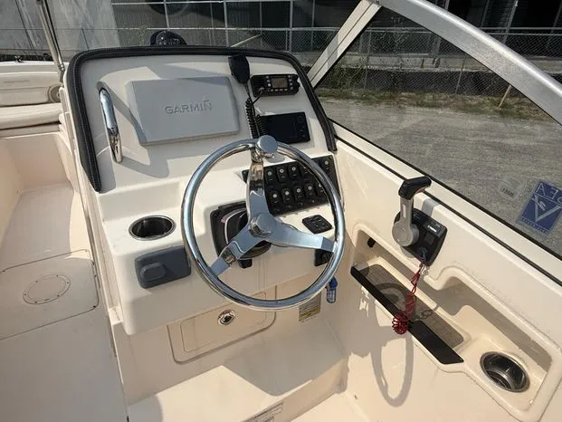 Slide: The Image of 2017 Grady-White Freedom 235 boat helm with Garmin navigation and steering wheel. - 6