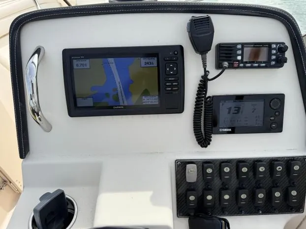 Slide: The Image of Control panel of 2017 Grady-White Freedom 235 boat with navigation and communication equipment. - 7