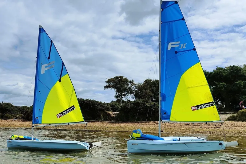 Slide: The Image of Two SERO Innovation Fusion II sailboats on calm water, 2025 model. - 6