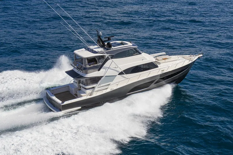 Slide: The Image of 2026 Riviera 72 Sports Motor Yacht Series II cruising on open water. - 0