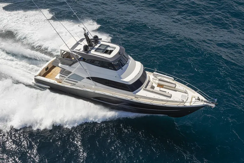 Slide: The Image of 2026 Riviera 72 Sports Motor Yacht Series II cruising on open water. - 1