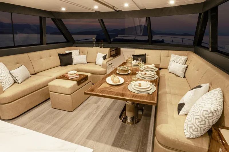 Slide: The Image of Luxurious interior of 2026 Riviera 72 Sports Motor Yacht, featuring elegant dining setup and plush seating. - 11