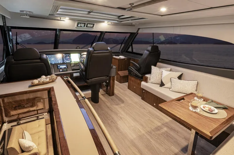 Slide: The Image of Luxurious interior of 2026 Riviera 72 Sports Motor Yacht Series II at sunset. - 13