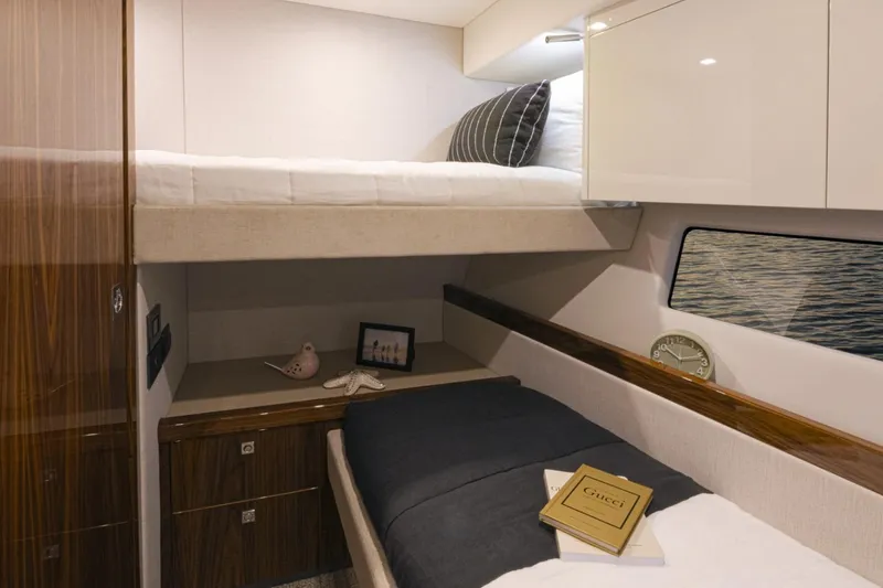 Slide: The Image of Luxurious cabin interior of 2026 Riviera 72 Sports Motor Yacht Series II with cozy bedding. - 25