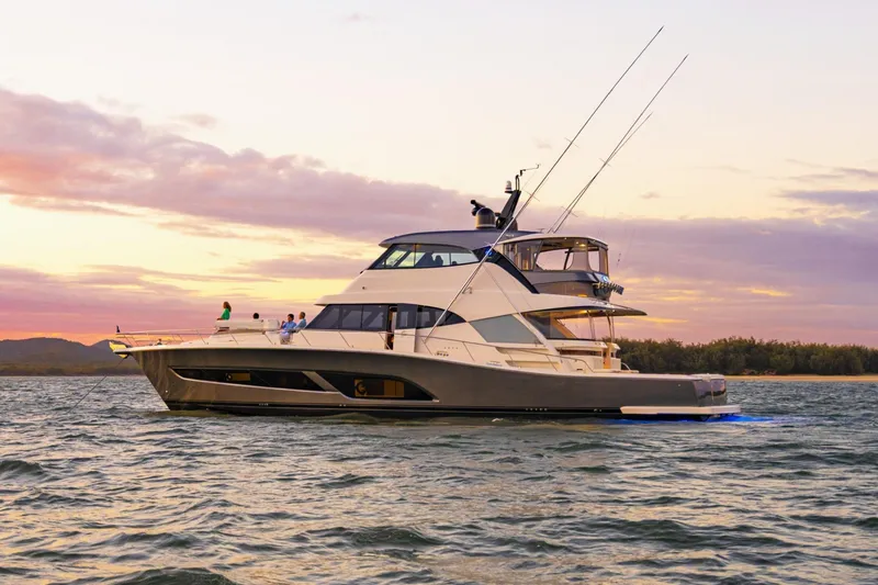 Slide: The Image of 2026 Riviera 72 Sports Motor Yacht Series II at sunset on the water. - 6
