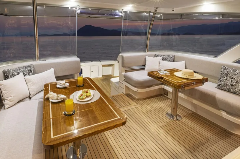Slide: The Image of Luxurious interior of 2026 Riviera 72 Sports Motor Yacht with elegant dining setup at sunset. - 8