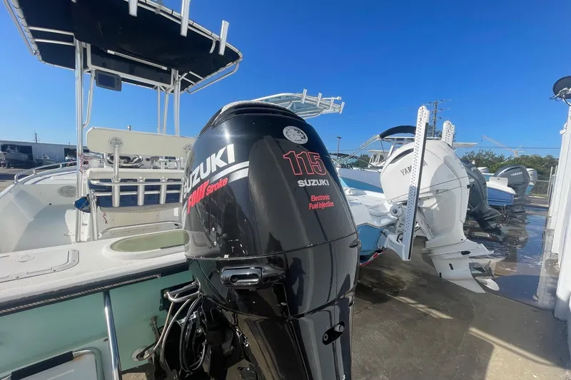 Slide: The Image of Boat with Suzuki 115 outboard motor, Slayer VS 19 model, 2012, in a marina setting. - 10