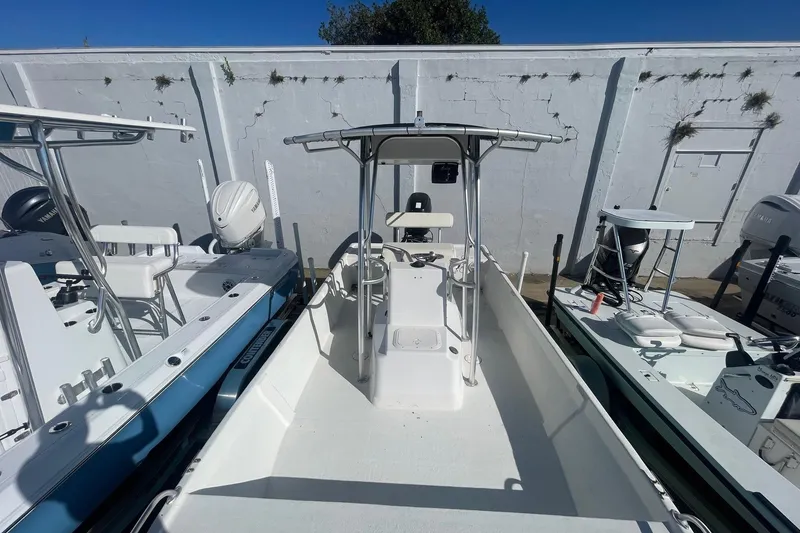 Slide: The Image of 2012 Slayer VS 19 boat with center console, parked outdoors. - 13