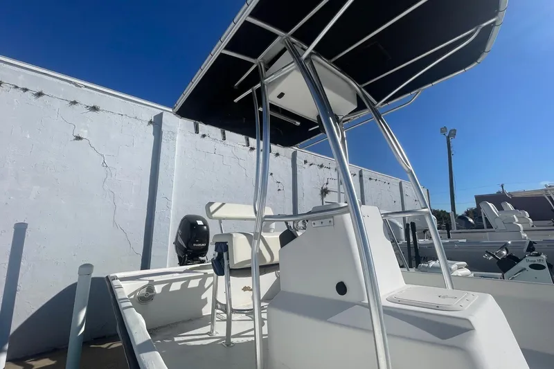 Slide: The Image of 2012 Slayer VS 19 boat with T-top and Suzuki outboard motor in a sunny marina. - 3