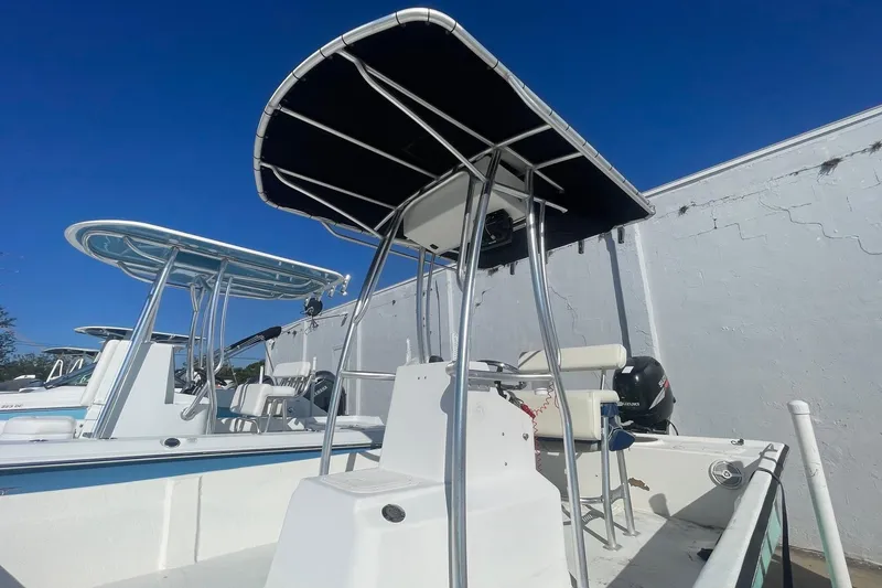 Slide: The Image of 2012 Slayer VS 19 boat with T-top canopy under clear blue sky. - 4