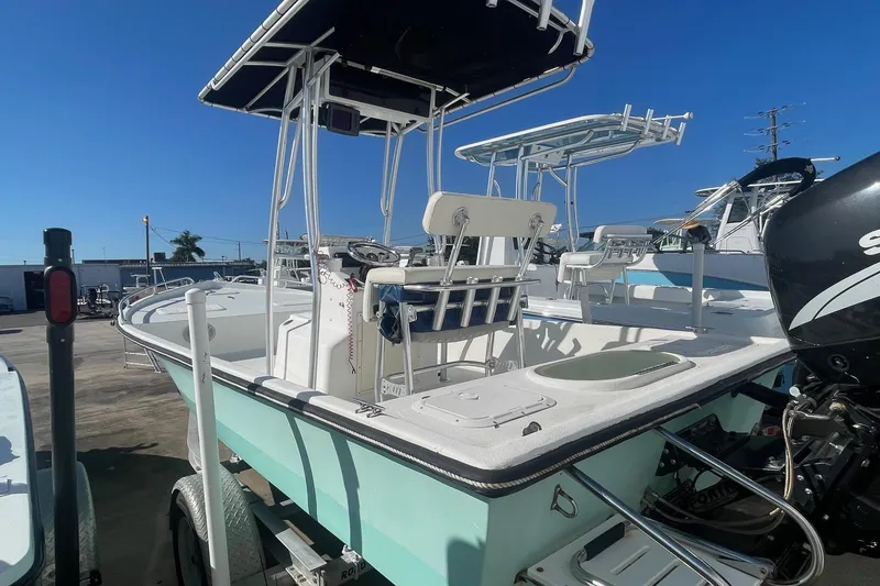 Slide: The Image of 2012 Slayer VS 19 boat with T-top and outboard motor in marina. - 6