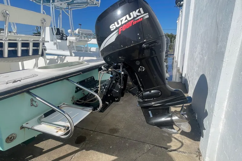 Slide: The Image of Boat with Suzuki Four Stroke engine, Slayer VS 19 model, 2012, docked under clear blue sky. - 7